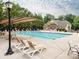 Community pool offers a place to relax and enjoy the sun with lounge chairs and a covered area at 3850 Hounslow Ln, Harrisburg, NC 28075