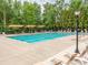 Community pool offers a cool place to relax and enjoy the sun, with tables and chairs around it at 3850 Hounslow Ln, Harrisburg, NC 28075