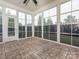 Bright sunroom featuring tiled floors and expansive windows offering a view of the backyard at 3850 Hounslow Ln, Harrisburg, NC 28075