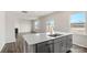 Modern kitchen island with sink and dishwasher, overlooking living room at 4622 Harris Elliot Rd, Lincolnton, NC 28092