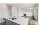 Modern kitchen island with sink and view into living room with fireplace at 4622 Harris Elliot Rd, Lincolnton, NC 28092