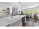 Modern kitchen with white cabinets, quartz countertops, a farmhouse sink, and an island at 48 Quiet Cv, Concord, NC 28027