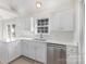 White kitchen features stainless steel appliances and quartz countertops at 550 Strathclyde Way, Rock Hill, SC 29730