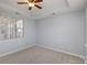 Spacious bedroom with ceiling fan and large window at 5726 Cactus Valley Rd # 238, Charlotte, NC 28277