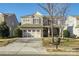 Two-story house with stone accents, two-car garage, and landscaping at 5726 Cactus Valley Rd # 238, Charlotte, NC 28277