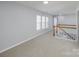 Upstairs hallway with carpet and access to bedrooms at 5726 Cactus Valley Rd # 238, Charlotte, NC 28277