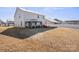 Expansive backyard featuring a covered patio area and well-manicured lawn at 9142 Mackinaw Dr, Gastonia, NC 28056