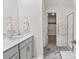 Bright bathroom featuring a gray vanity, floral towel, and doorway to walk-in closet at 9142 Mackinaw Dr, Gastonia, NC 28056