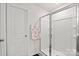 Bathroom with a glass enclosed shower, floral towel, and white door at 9142 Mackinaw Dr, Gastonia, NC 28056
