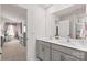 Bright bathroom featuring a double sink vanity, large mirror, and doorway to bedroom at 9142 Mackinaw Dr, Gastonia, NC 28056