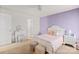Charming bedroom featuring a bed, vanity, nightstand and pastel color accent wall at 9142 Mackinaw Dr, Gastonia, NC 28056