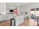 Modern kitchen with a large kitchen island, stainless steel appliances, and a view of the living room at 9142 Mackinaw Dr, Gastonia, NC 28056
