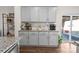 Kitchen with granite counters, gray cabinets, butler's pantry, and a view to the outdoor patio area at 9142 Mackinaw Dr, Gastonia, NC 28056