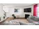 Bright living room with a fireplace, TV, and comfortable gray sofa at 9142 Mackinaw Dr, Gastonia, NC 28056