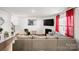 Open living room with fireplace, TV, gray sectional and hardwood floors at 9142 Mackinaw Dr, Gastonia, NC 28056