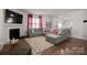 Open-concept living room with views of the kitchen and a modern gray sectional at 9142 Mackinaw Dr, Gastonia, NC 28056