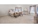 Bright main bedroom featuring a bed, two chairs, and natural light from the windows at 9142 Mackinaw Dr, Gastonia, NC 28056