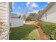 Fenced backyard with grassy area and privacy bushes and the home's siding can be seen at 1005 Jody Dr, Matthews, NC 28104