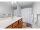 Clean bathroom features a wood vanity and a shower with a decorative shower curtain at 1005 Jody Dr, Matthews, NC 28104