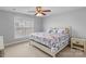 Cozy bedroom features a ceiling fan and a large window that provides natural light at 1005 Jody Dr, Matthews, NC 28104