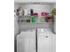 A well-organized laundry room with a white washer and dryer and lots of shelving for storage at 1005 Jody Dr, Matthews, NC 28104