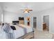 This main bedroom features carpet, ceiling fan, lots of natural light, a walk-in closet and en-suite bathroom at 1005 Jody Dr, Matthews, NC 28104