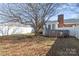 Lush backyard featuring a well-maintained lawn, a mature tree, and a fenced perimeter at 101 Griffin St, Stanley, NC 28164