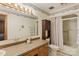 Standard bathroom featuring a shower-tub combo, vanity, and decorative wallpaper at 101 Griffin St, Stanley, NC 28164