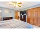 Cozy bedroom featuring classic wooden closet, dresser, ceiling fan, and blue-grey colored walls at 101 Griffin St, Stanley, NC 28164