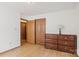 Bright bedroom with wood floors, a dresser, closet, and neutral wall colors at 101 Griffin St, Stanley, NC 28164