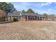 Attractive brick home enhanced with green shutters, highlighted by a wide, grassy front lawn at 101 Griffin St, Stanley, NC 28164