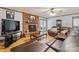 Spacious living room features a brick fireplace, wood flooring, and a comfortable leather sectional at 101 Griffin St, Stanley, NC 28164