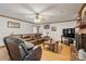 Inviting living room featuring a cozy fireplace, leather furniture, and gleaming hardwood floors at 101 Griffin St, Stanley, NC 28164