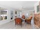 Bright sun room with windows, brick accent wall and comfortable wicker seating at 101 Griffin St, Stanley, NC 28164