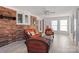 Inviting sun room featuring brick walls, ample lighting, and cozy wicker furniture at 101 Griffin St, Stanley, NC 28164