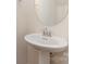 Small bathroom with pedestal sink and oval mirror at 10422 Ebbets Rd, Charlotte, NC 28273