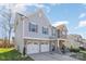 Two-story house with gray siding, stone accents, and a three-car garage at 10422 Ebbets Rd, Charlotte, NC 28273