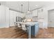 Modern kitchen with white shaker cabinets, a large island, and stainless steel appliances at 114 Quail Ridge Dr, Mooresville, NC 28117