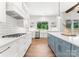 Modern kitchen featuring white cabinets, quartz countertops, and a farmhouse sink at 114 Quail Ridge Dr, Mooresville, NC 28117