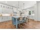 Bright kitchen with white cabinets, blue island, and stainless steel appliances at 114 Quail Ridge Dr, Mooresville, NC 28117