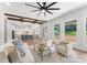 Open living room with exposed beams, a view of the kitchen, and access to backyard at 114 Quail Ridge Dr, Mooresville, NC 28117