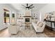 Cozy living room with a fireplace, built-in shelving, and large windows at 114 Quail Ridge Dr, Mooresville, NC 28117