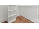 Built-in shelving unit with three shelves and wood flooring at 114 Quail Ridge Dr, Mooresville, NC 28117