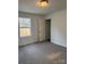 Bright bedroom with neutral carpeting and an open closet at 118 Valley Springs Dr, Olin, NC 28660