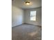 Spacious bedroom with neutral carpeting and a large window at 118 Valley Springs Dr, Olin, NC 28660