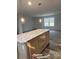 Kitchen island with light wood cabinets and a marble countertop at 118 Valley Springs Dr, Olin, NC 28660