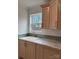 Bright laundry room with wood cabinets and a built-in sink at 118 Valley Springs Dr, Olin, NC 28660