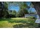 Large backyard with detached garage and lush green grass at 11828 Mirror Lake Dr, Charlotte, NC 28226