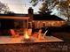 Cozy patio with fire pit and string lights, perfect for outdoor entertaining at 11828 Mirror Lake Dr, Charlotte, NC 28226