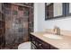 Bathroom showcasing a dark vanity with light countertops and a beautifully tiled walk-in shower at 11828 Mirror Lake Dr, Charlotte, NC 28226